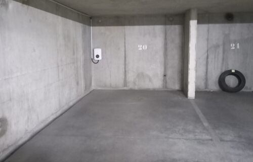 Grande place de parking sécurisé avec borne de recharge